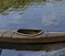 scene of boat on lake by rusty container